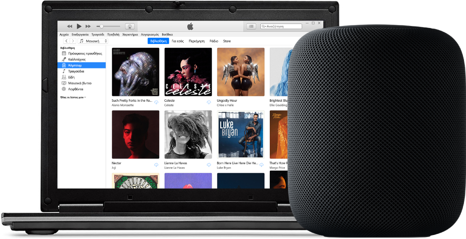 Ένα PC με το iTunes στην οθόνη και ένα HomePod κοντά.