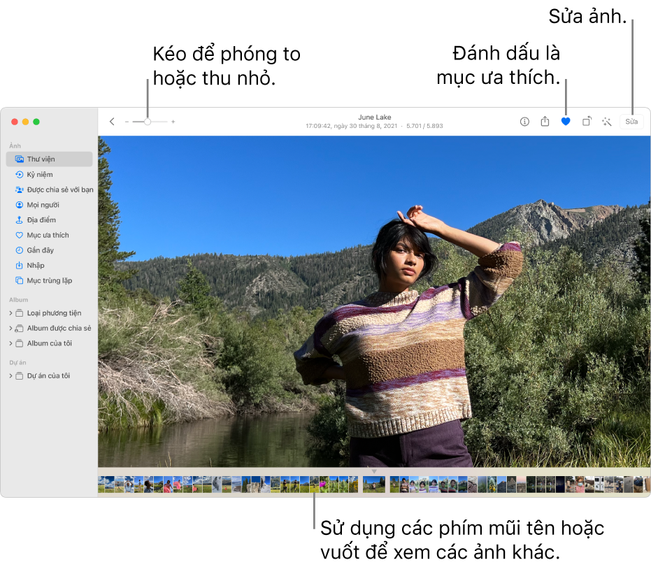 Cửa sổ Ảnh đang hiển thị ảnh được phóng to ở bên phải với một hàng các hình thu nhỏ bên dưới. Thanh công cụ ở trên cùng bao gồm thanh trượt Thu phóng, nút Mục ưa thích và nút Sửa.