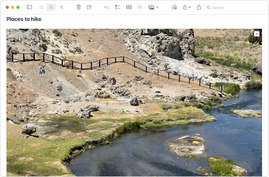 A Notes app window on Mac showing a note that includes a large photo of a hill and a river.