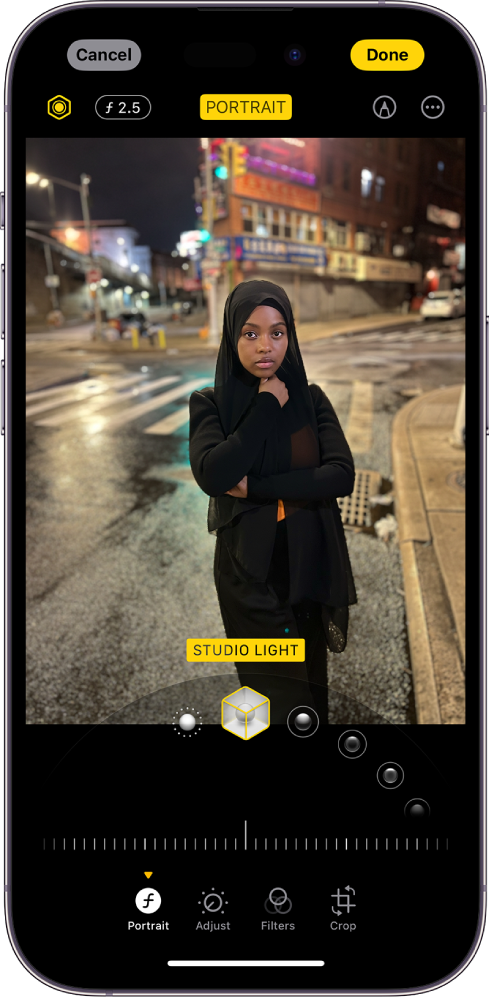 The Edit screen of a portrait. The photo is in the center of the screen and below the photo are the Portrait Lighting options. Studio Light is selected. Below that is a slider to adjust the level of the effect. At the bottom of the screen from left to right are the Portrait, Adjust, Filters, and Crop buttons. The Portrait button is selected.