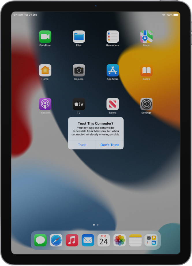 An iPad showing the Trust This Computer? dialogue when first connected to a MacBook Pro.