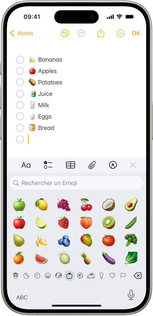 Une note est ouverte dans l’app Notes dans la moitié supérieure de l’écran et le clavier des Emoji est ouvert dans la moitié inférieure.