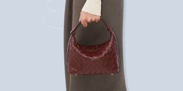 a hand holding a brown bag