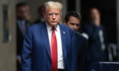 Donald Trump, wearing blue suit and red tie, walks into court