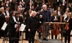 conductor Simon Rattle leaves the podium to John Adams after the world premiere of the composer’s Frenzy.