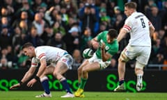 Ireland’s Hugo Keenan (centre) on his way down after the challenge by England’s Freddie Steward