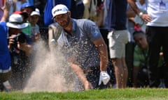 Dustin Johnson plays his third shot from a bunker on the second hole.