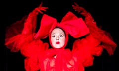 Paulina Lenoir in red dress, red gloves and red headpiece on black background