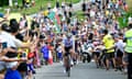 Tour de France spectators cheer as riders speed by.