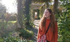 Girl with long hair walking through garden