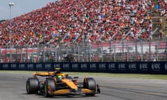 McLaren’s Lando Norris drives his F1 car past a stand full of fans at Imola