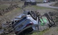 Wrecked cars lie beside the road in Napier, Hawke’s Bay, New Zealand, after Cyclone Gabrielle. Eight are still missing, with more wild weather expected.