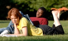 Students reading books in a park