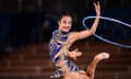 a woman performs with a hula hoop