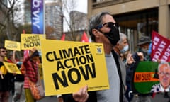 Protesters hold placards during a rally marking World Environment Day