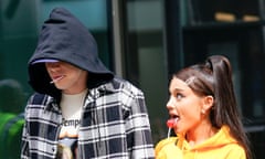 Ariana Grande and Pete Davidson, sucking on lollipops and holding hands, in New York, 20 June 2018