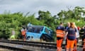 Emergency personnel at work near to a crashed bus by a railway line outside Nove Zamky, Slovakia