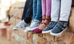 Children sitting on a wall