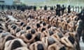 Members of the military police of public order guard gang members after the Honduras armed forces took over the control of the prisons, in this handout picture released on 26 June.