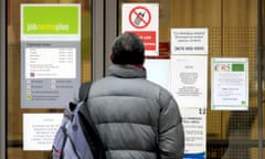 A man stands outside a Jobcentre Plus office in Westminster, London.