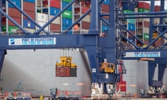 Shipping containers are unloaded from a cargo ship at the Port of Felixstowe