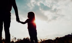 silhouette of a small child holding an adult's hand