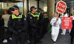 Protest at Siemens Mobility in Melbourne<br>epa08058977 A climate change protester holds a sign in front of Victorian Police officers during a demonstration outside of Siemens Mobility in Docklands, Melbourne, Victoria, Australia, 10 December 2019. Protesters are demanding the company to refuse their impending contract for signaling services on Adani’s controversial Carmichael Rail Project. EPA/JAMES ROSS AUSTRALIA AND NEW ZEALAND OUT