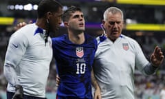 Christian Pulisic is helped off the pitch after suffering a pelvic injury against Iran on Tuesday
