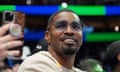 Jamie Foxx smiles at a basketball match