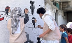 Artists in Rafah paint on a wall to commemorate the thousands of children who lost their lives as a result of Israeli attacks, as part of Palestinian Child's Day on 4 March, 2024
