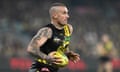 Dustin Martin carries the ball for Richmond against Essendon