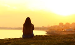 A single woman watching a sunset.