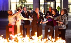 Greenpeace activists dressed as Shell board members hold a mock profits party behind a burning sign reading ‘Your Future’ during a protest outside Shell's headquarters in London.