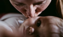 Happy mother kissing her thoughtful-looking baby girl