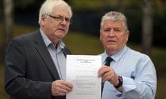 Michael Gallagher (left) and Stanley McComb hold the writ against George Hamilton