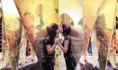 An artist's impression image of a kissing booth art installation project to be set up in New York's Times Square. A young couple kiss amid a ring of nine mirrored hearts.