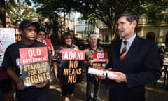 Murrawah Johnson of the Wangan and Jagalingou people (W&J) presents a Declaration of Defence of Country to Queensland's Speaker of the House Peter Wellington outside Parliament House in Brisbane, Thursday, March 26, 2015. The W&J people have announced that they have refused Indian conglomerate Adani
and the QLD government a Land Use Agreement for the Carmichael coal mine, 
the biggest in Australian history, on their traditional lands.  (AAP Image/Dan Peled) NO ARCHIVING