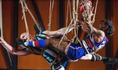 Still Lives exhibition with AFL players tied up in rope and suspended from the ceiling