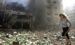 A woman runs past a destoyed building, still in flames, after it was attacked by Israeli warplane missiles, in the southern suburbs of Beirut, Lebanon Monday Aug. 7, 2006. At daybreak Monday, Israeli warplanes pounded Beirut's southern suburbs with eight airstrikes, stepping up bombardment of the Hizbullah stronghold. It was not immediately clear what was targeted. (AP Photo/Lefteris Pitarakis) Hizbullah Lebanon Israel war