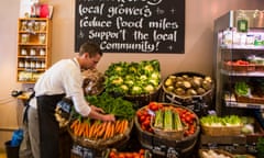 A shopkeeper arranges fruit and vegetables in Wadebridge, North Cornwall. 