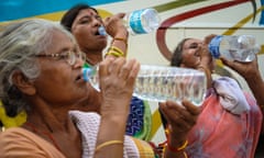 Women drinking bottles of water in Kolkata, India during the April heatwave