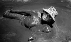 Woman in mud on the Turda mudflats, Romania.