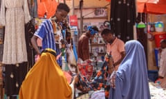 Women browse fabrics in a street market in Mogadishu, Somalia, 12 December 2023. 
