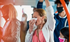 Woman wiping her nose on a bus