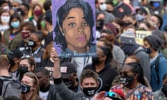 FILES-US-JUSTICE-POLICE-SHOOTING-RACISM<br>(FILES) In this file photo taken on March 13, 2021 A protestor brandishes a portrait of Breonna Taylor during a rally in remembrance on the one year anniversary of her death in Louisville, Kentucky. - The US Justice Department announced on Agust 4, 2022 that it was charging four police officers over the death of Breonna Taylor, a Black woman killed in a botched 2020 raid on her home in Louisville, Kentucky. (Photo by Jeff Dean / AFP) (Photo by JEFF DEAN/AFP via Getty Images)