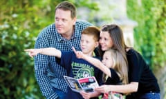 Family looking at a map and following clues on a Treasure Trail in the UK countryside.