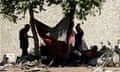 An unhoused encampment shaded by a tree in Sacramento, California.