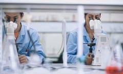 Scientists working in laboratory with microscopes<br>GettyImages-84527976