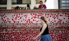 A woman walks past the National Covid Memorial Wall in London