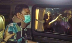 Former Thai prime minister Thaksin Shinawatra sits in a vehicle after being released on parole in Bangkok.